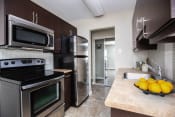 Thumbnail 6 of 15 - a kitchen with stainless steel appliances and a sink