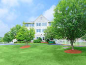 Thumbnail 13 of 65 - a large white house with a lawn and trees in front of it