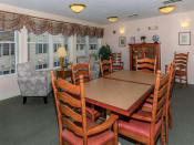Thumbnail 21 of 65 - a dining room with a wooden table and chairs