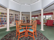 Thumbnail 23 of 65 - a dining room with a table and chairs in a library