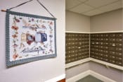 Thumbnail 49 of 65 - a locker room with a wall hanging with a quilt on it and a locker