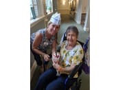 Thumbnail 57 of 65 - a woman in a wheel chair and another woman holding a cupcake