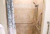 Thumbnail 30 of 55 - a handicap accessible shower in a bathroom with a shower curtain