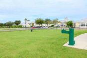 Thumbnail 19 of 55 - a park with a green pole in the grass