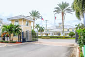 Thumbnail 2 of 55 - a street with palm trees in front of a building with flags