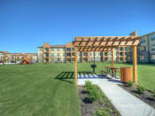 Thumbnail 28 of 28 - a pergola sits in the middle of a grassy area with a playground in the