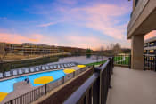 Thumbnail 1 of 22 - a balcony with a pool and a river at sunset