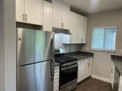 Thumbnail 27 of 27 - a kitchen with white cabinets and stainless steel appliances