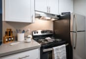 Thumbnail 1 of 27 - a kitchen with white cabinets and stainless steel appliances