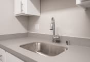 Thumbnail 9 of 27 - a kitchen sink with a faucet in a 555 waverly unit
