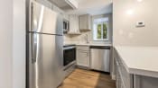 Thumbnail 7 of 28 - a kitchen with stainless steel appliances and white cabinets