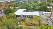 Thumbnail 28 of 28 - an aerial view of a building surrounded by trees and a parking lot