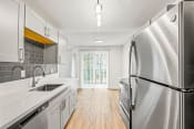 Thumbnail 24 of 42 - a kitchen with white cabinets and stainless steel appliances