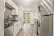 Thumbnail 10 of 42 - a kitchen with white cabinets and stainless steel appliances