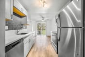 Thumbnail 35 of 42 - a kitchen with white cabinets and stainless steel appliances
