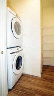 Thumbnail 71 of 77 - a full size washer and dryer in a room with a wooden floor