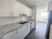Thumbnail 6 of 14 - a kitchen with white cabinets and a stainless steel sink