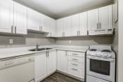 Thumbnail 8 of 14 - a kitchen with white cabinets and white appliances
