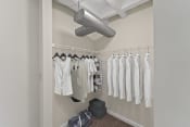 Thumbnail 23 of 52 - a walk in closet with a ceiling fan