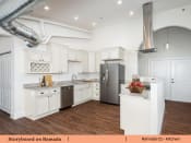 Thumbnail 51 of 58 - a kitchen with white cabinets and stainless steel appliances