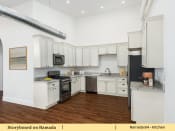 Thumbnail 41 of 58 - a kitchen with white cabinets and a stove and a refrigerator