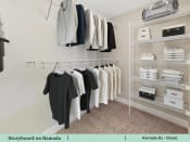 Thumbnail 31 of 58 - a walk in closet with a rack of clothes on the wall