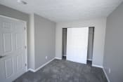 Thumbnail 9 of 11 - Bedroom with a closet and a door at Canterbury House apartments in Logansport, Indiana