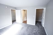Thumbnail 7 of 11 - Empty bedroom with three doors and a closet at Conner Court apartments in Connersville, IN
