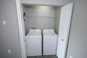 Thumbnail 6 of 11 - White washer and dryer in a room at Canterbury House apartments in Logansport, Indiana