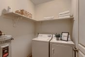 Thumbnail 15 of 46 - Fairview, OR Apartments for Rent - Laundry Room with Shelving and In-Unit Washer and Dryer.