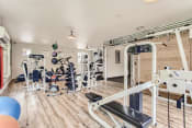 Thumbnail 26 of 46 - Fairview Apartments for Rent-Lodges at Lake Salish-Fitness Center with Equipment, Hardwood Style Flooring, Large Windows, and Overhead Lighting