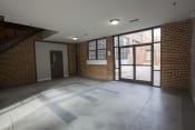 Thumbnail 18 of 18 - an empty room with a large glass door and a brick wall