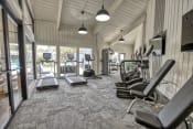 Thumbnail 1 of 18 - a spacious fitness center with treadmills and other exercise equipment