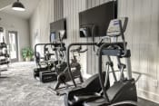 Thumbnail 12 of 18 - a gym with treadmills and elliptical machines