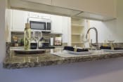 Thumbnail 3 of 37 - This is a photo of the kitchen of a 1245 square foot 2 bedroom apartment at Cambridge Court Apartments.