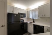 Thumbnail 5 of 37 - This is a photo of the kitchen in the 450 square foot efficiency apartment at Cambridge Court Apartments in Dallas, TX.