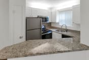 Thumbnail 8 of 37 - This is a photo of the kitchen in the 450 square foot efficiency apartment at Cambridge Court Apartments in Dallas, TX.