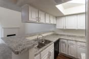 Thumbnail 7 of 37 - This is a photo of the kitchen  breakfast bar in a 717 square foot 1 bedroom, 1 bath apartment at Canyon Creek Apartments in Dallas, TX