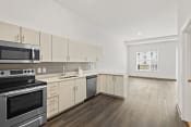 Thumbnail 28 of 71 - a kitchen with white cabinets and stainless steel appliancesat Metropolis Apartments, Glen Allen