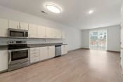 Thumbnail 7 of 71 - an empty kitchen with white cabinets and stainless steel appliancesat Metropolis Apartments, Glen Allen, 23060