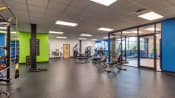 Thumbnail 40 of 46 - a large fitness room with cardio machines and weights at The Hudson, Richmond, 23224