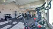 Thumbnail 40 of 53 - a gym with treadmills and other exercise equipment in a building with windows