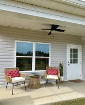 Thumbnail 36 of 40 - a front porch with chairs and a table and a ceiling fan