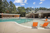Thumbnail 12 of 58 - our apartments have a large swimming pool with orange chairs