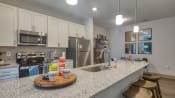 Thumbnail 24 of 53 - a kitchen with granite counter tops and stainless steel appliances