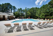 Thumbnail 13 of 58 - Swimming Pool with Lounge Chairs at Shellbrook Apartments in Raleigh NC