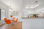 Thumbnail 27 of 100 - a kitchen and dining area in a 555 waverly unit