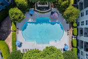 Thumbnail 7 of 26 - arial view of a swimming pool surrounded by trees and umbrellas
