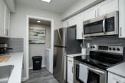 Thumbnail 21 of 26 - a kitchen with white cabinets and stainless steel appliances