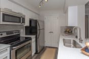 Thumbnail 24 of 26 - a kitchen with white cabinets and stainless steel appliances